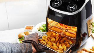 Close up of a Tower air fryer with baskets filled of chips