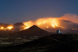 wildfires and controlled burns compete for fuel in the West Texas mountains.">Frank Cianciolo/McDonald Observatory
