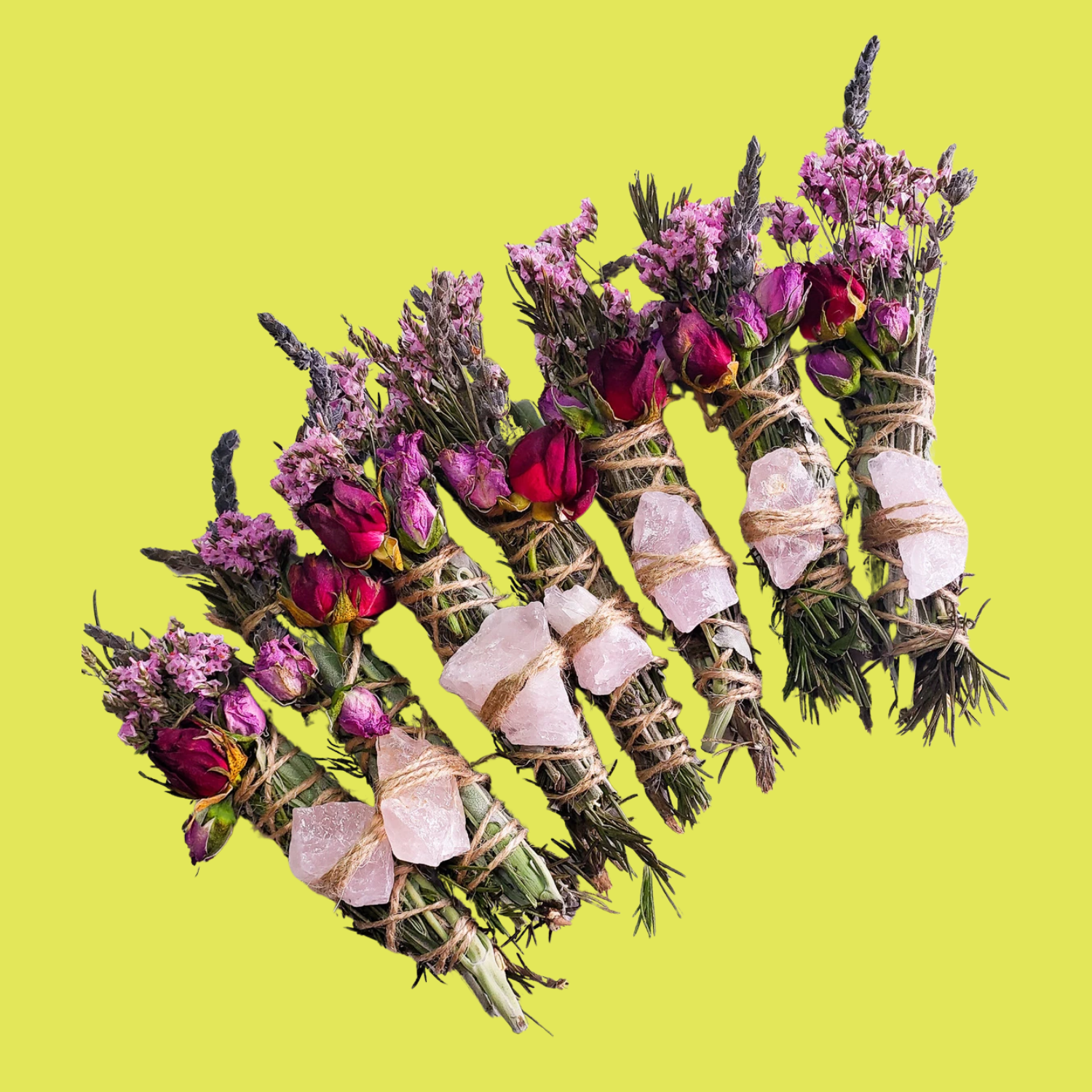 A set of floral and herb smudge sticks with rose quartz crystals