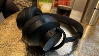 A black pair of Cambridge Audio Melomania P100 headphones on a table
