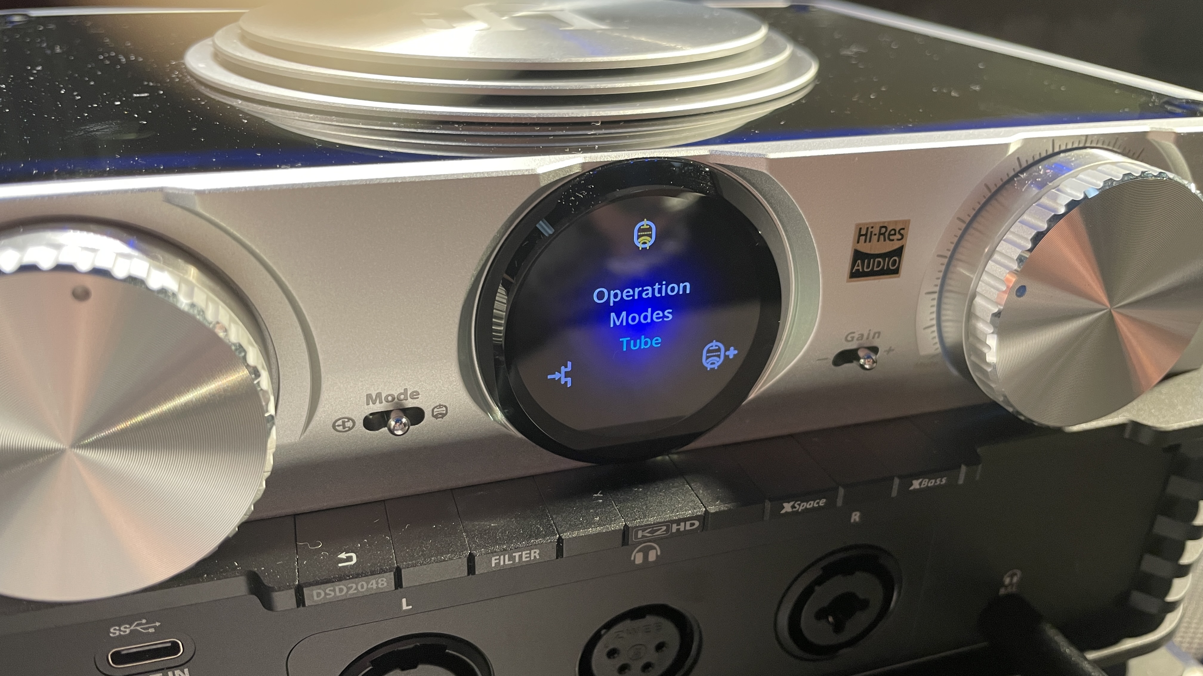 The formidable iFi iDSD Phantom in Tower Bridge, London, used with headphones and illuminating the front panel 