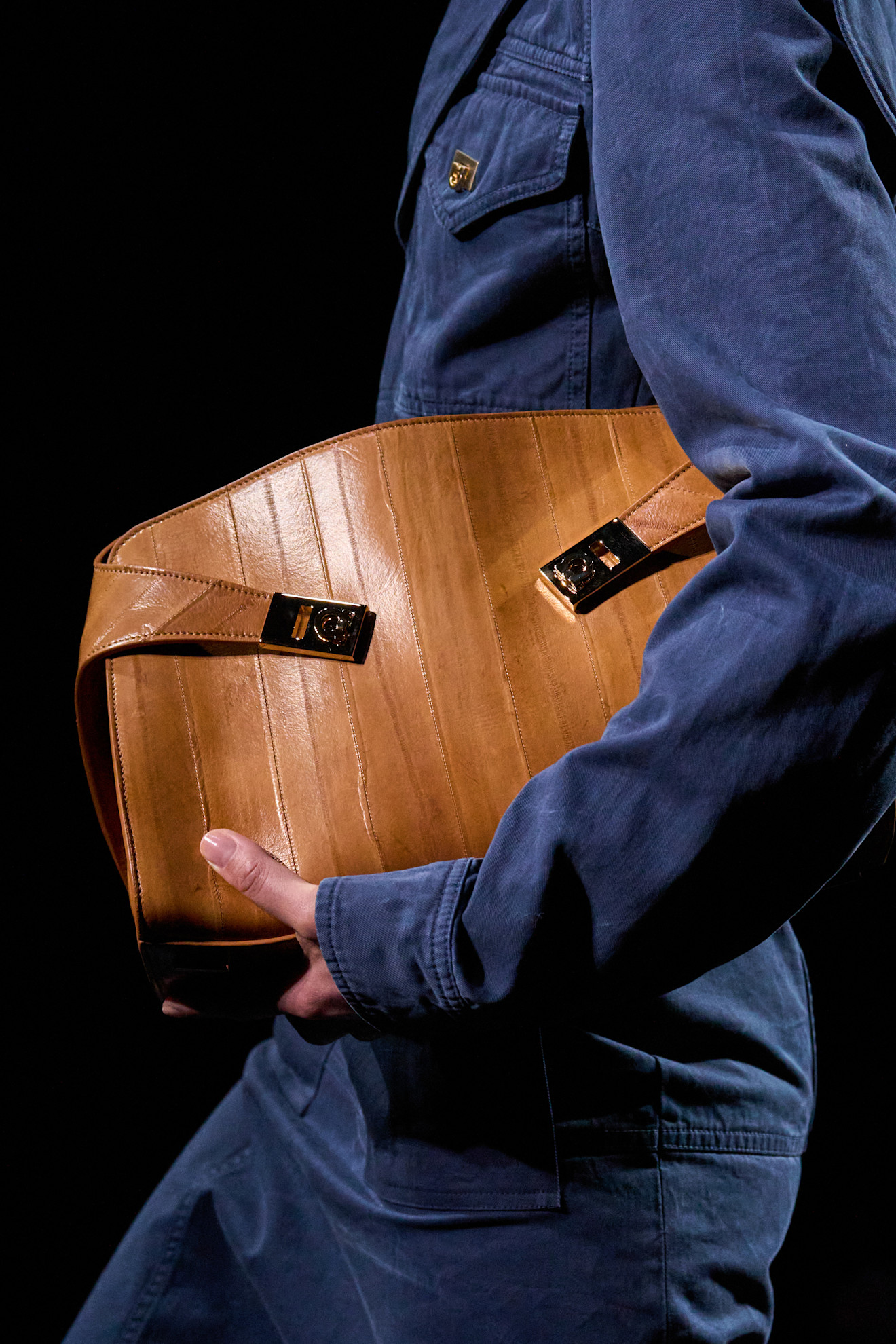 an image of a women holding the ferragamo hug bag.