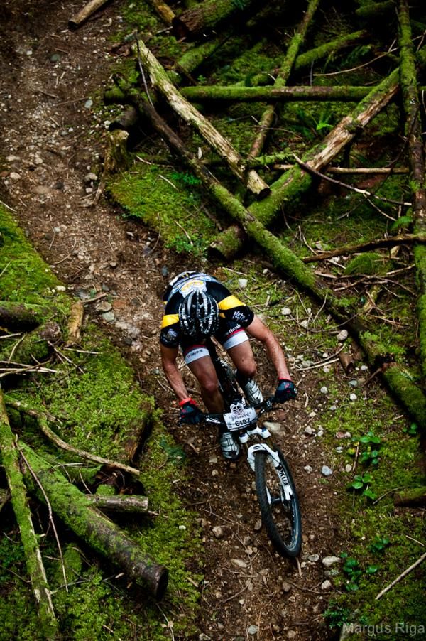 A racer flies through some mossy singletrack
