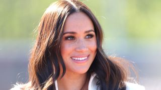 Meghan Markle smiling as she attends the Athletics Competition during day two of the Invictus Games The Hague 2020 at Zuiderpark on April 17, 2022 in The Hague, Netherlands
