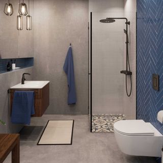 minimalist bathroom with wall-hung toilet and blue herringbone wall tiles and walk in shower with rainshower