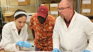 DNA sample collection by Raquel Fleskes (U Conn), while Ade Ofunniyin (Gullah Society) and Ted Schurr (U Penn) look on.