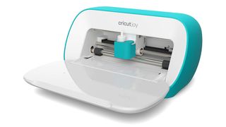 Cricut vs Silhouette; the best embossing machine, a small blue and white Cricut Joy embossing and cutting machine