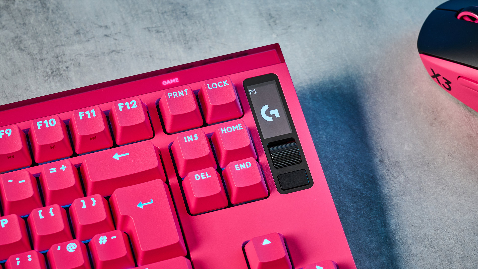 A photo of the Logitech G Pro X2 Rapid keyboard in hot pink on a stone surface