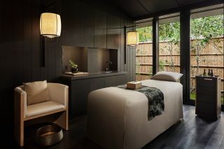 Treatment room at the Aman spa in Kyoto, Japan with wooden walls and lanterns
