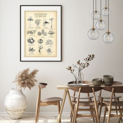 neutral dining room with large artwork, glass cluster pendant lights, wood designer style dining chairs and table, earthenware style pot, herringbone floor
