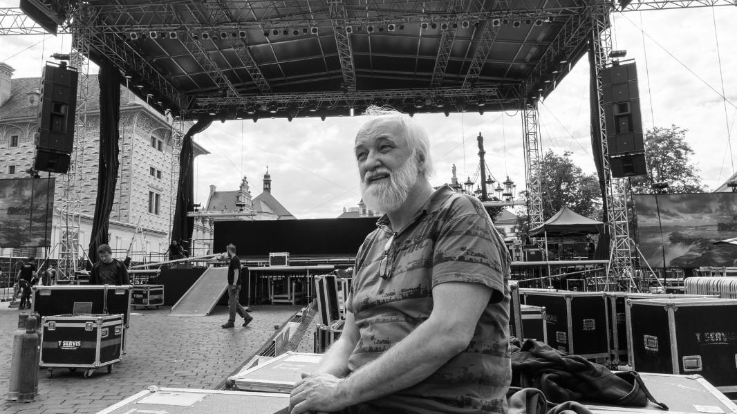 Founder of KV2 Audio George Krampera Sr. in a black and white photo in front of a concert stage.