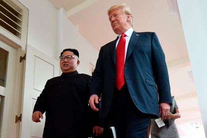 Trump and Kim Jong Un walking. 
