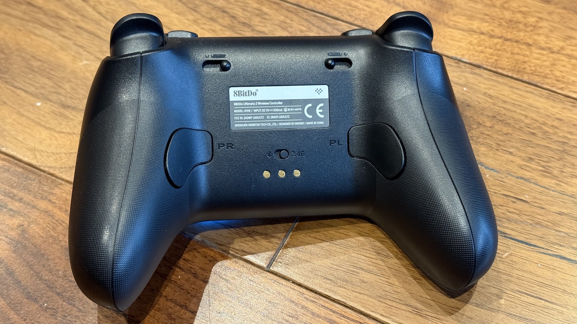 The 8BitDo Ultimate 2 controller, with dock and USB connection at home