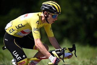 Team UAE Emirates Tadej Pogacar of Slovenia wearing the overall leaders yellow jersey rides in the pack during the 19th stage of the 108th edition of the Tour de France cycling race 207 km between Mourenx and Libourne on July 16 2021 Photo by AnneChristine POUJOULAT AFP Photo by ANNECHRISTINE POUJOULATAFP via Getty Images