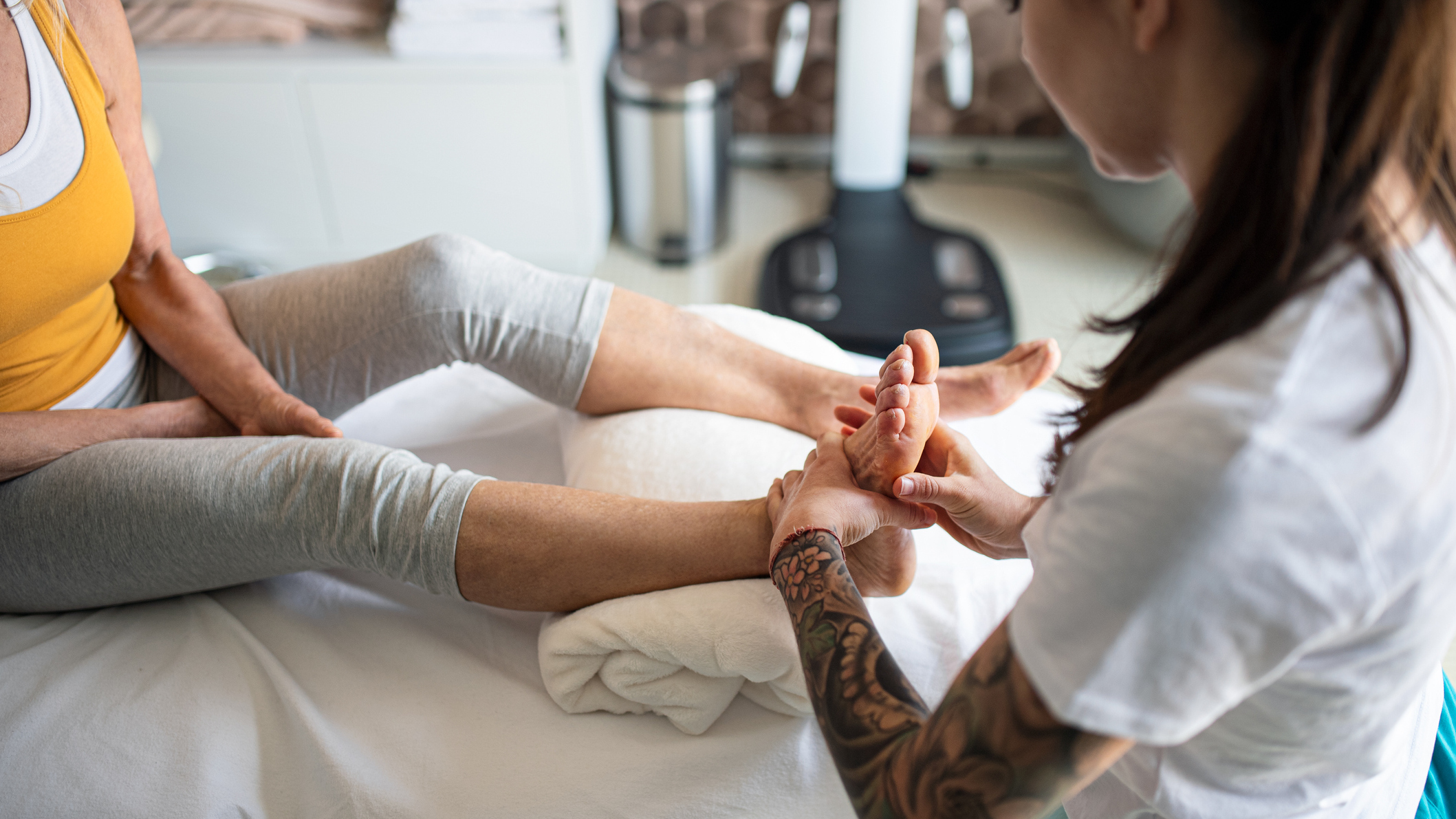 Woman receiving sports massage on her feet