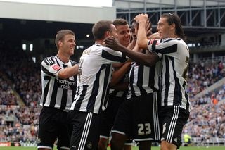 Newcastle players celebrating a goal at St James' Park