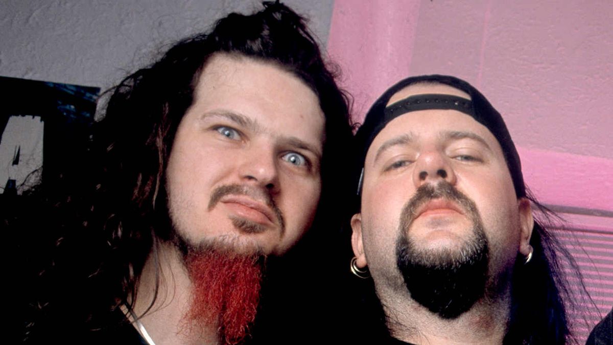 Pantera guitarist Dimebag Darrell resting his head on drummer Vinne Paul’s shoulder