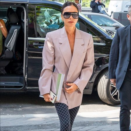 Victoria Beckham in a blazer and tights