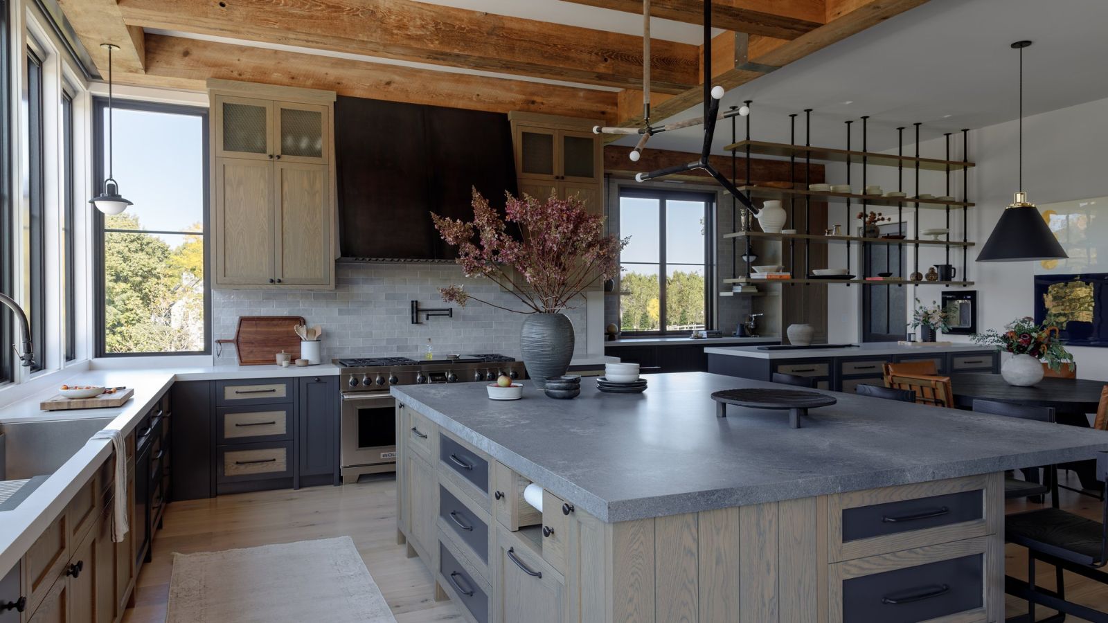 Modern rustic kitchen with wooden and gray cabinets, gray countertops and wooden beams