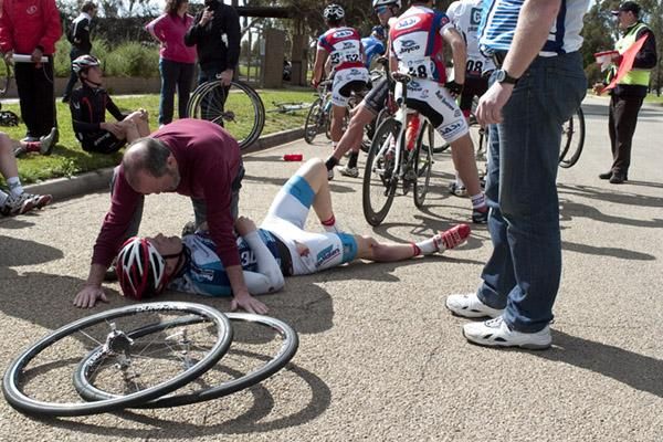 Jeremy Stephens (Black Peloton) from New Zealand is attended to by tour medical officer Bobby Hall after a nasty fall on stage eight.