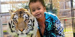 Miles, son of Chrissy Teigen, photoshopped onto an image of the Tiger King.