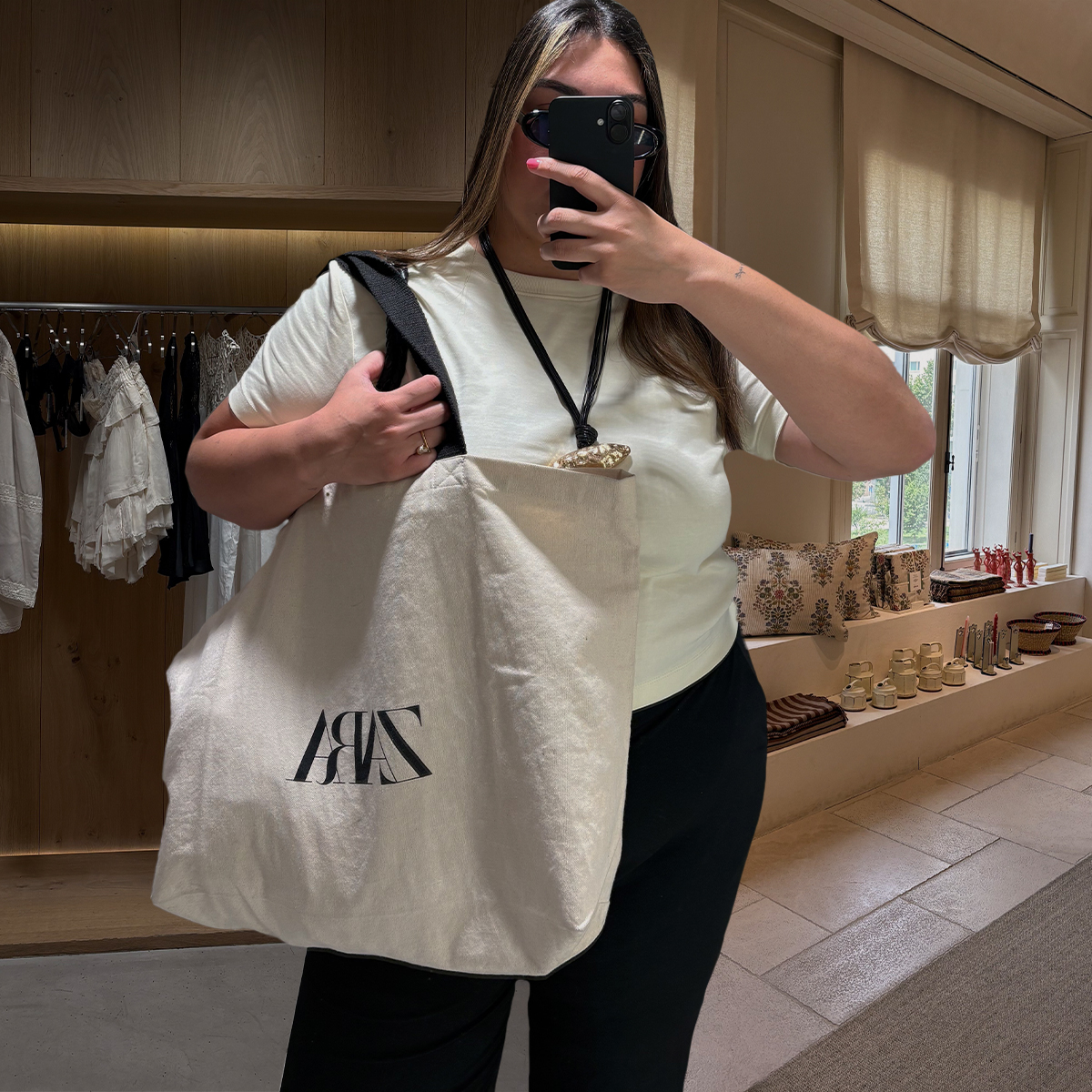 Photos of Who What Wear editor Ana Escalante trying on different Zara summer items in Zara Spain fitting room while visiting Madrid.