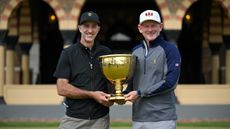 US Team captain Brandt Snedeker and International Team captain Geoff Ogilvy hold the Presidents Cup together at Medinah Country Club on April 28, 2025.