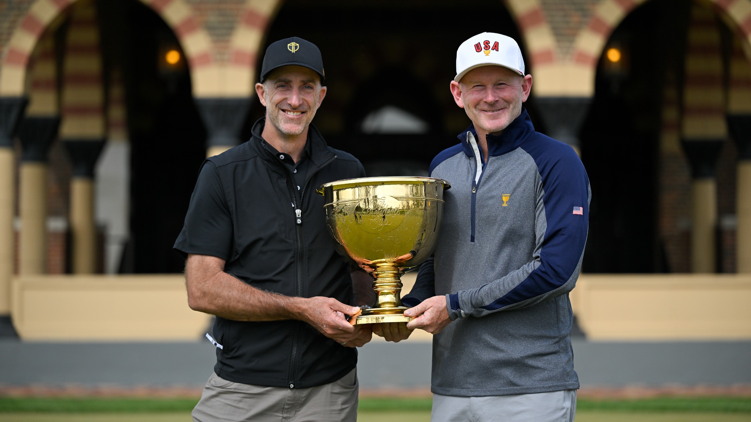 US Team captain Brandt Snedeker and International Team captain Geoff Ogilvy hold the Presidents Cup together at Medinah Country Club on April 28, 2025.