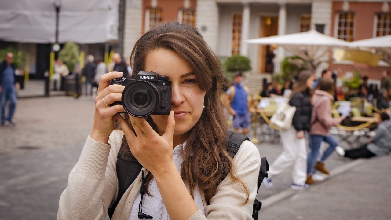 The Fujifilm X-H2S being held by a photographer in Covent Garden, London