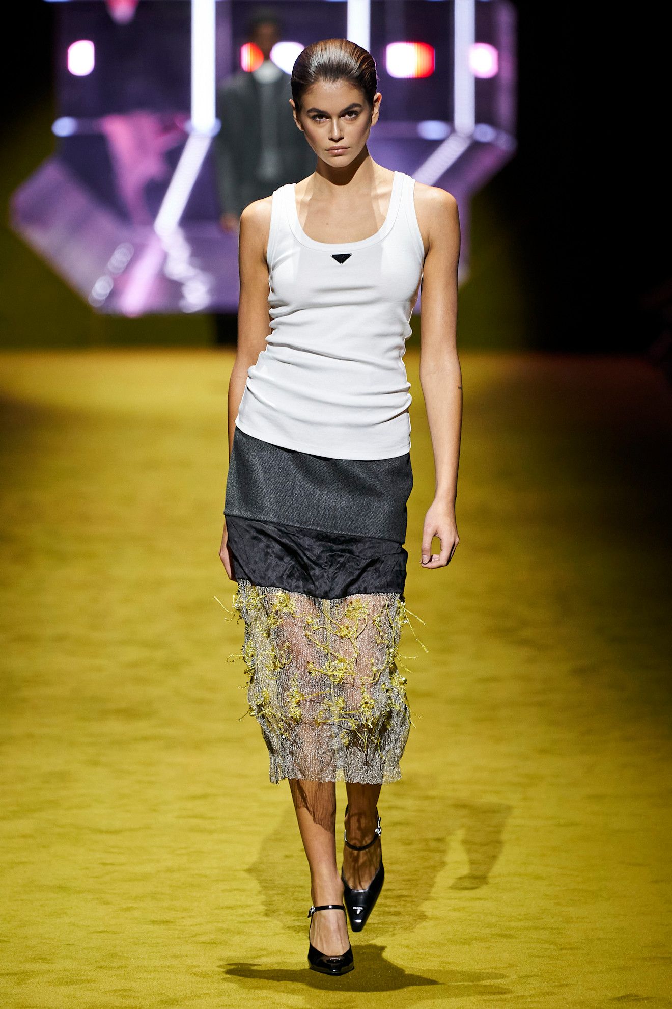 An image of a white tank top on Prada's autumn/winter 2022 runway.