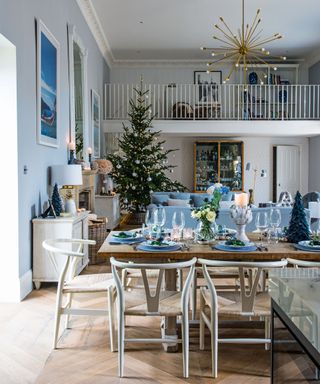 Large open-plan dining an living room decorated for christmas