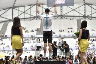Chris Froome climbs the podium after stage 20 of the Tour de France.