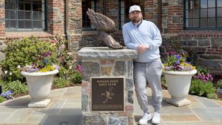 Dave LeClair next to the Winged Foot statue