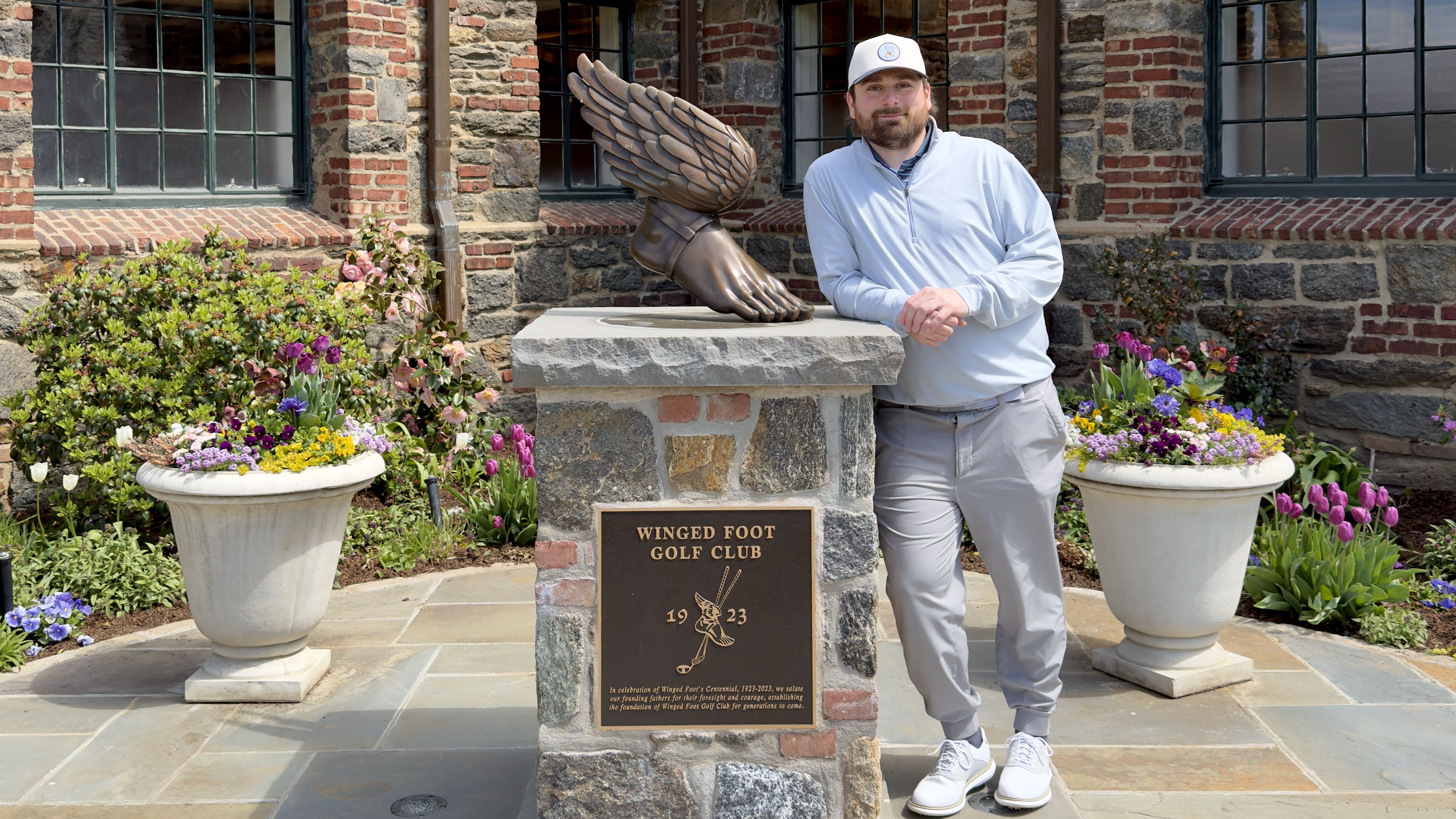 Dave LeClair next to the Winged Foot statue