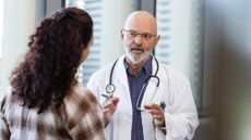 Emergency room doctor talks with patient's family member