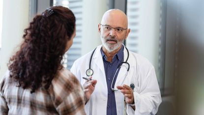 Emergency room doctor talks with patient's family member