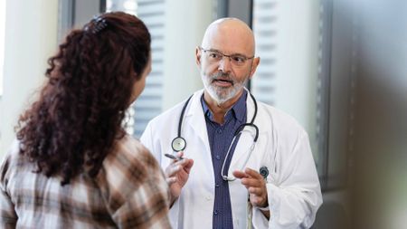 Emergency room doctor talks with patient's family member