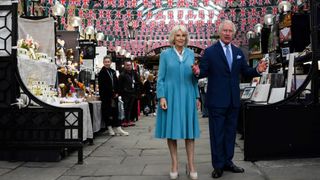 King Charles III and Queen Camilla look at stands at Covent Garden