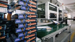 Pandemic board game boxes stacked in a factory