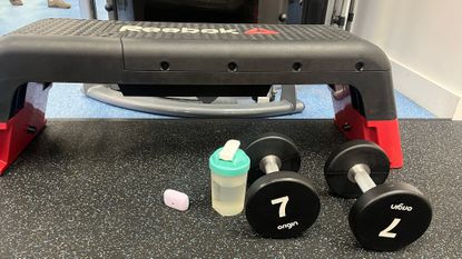 Dumbbells and step in a gym