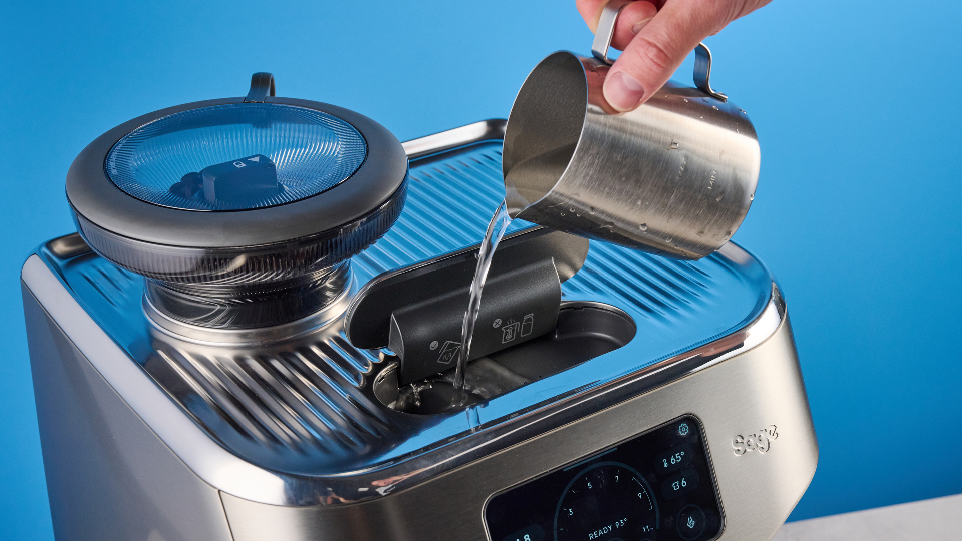 the breville oracle dual boiler / sage oracle dual boiler in stainless steel, showing its touchscreen, steam wand, built in grinder, and espresso shots
