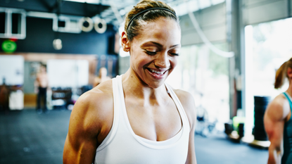 Woman with upper body muscles smiling