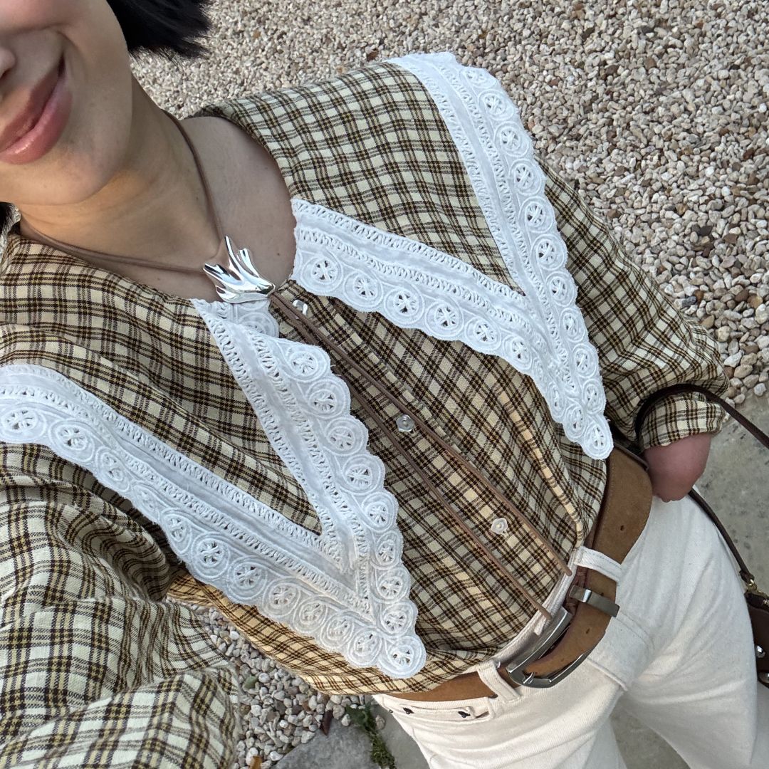 April Lockhart wearing a plaid shirt with a lace trimmed bib collar