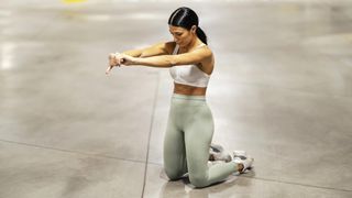 a woman doing the pilates kneeling lean