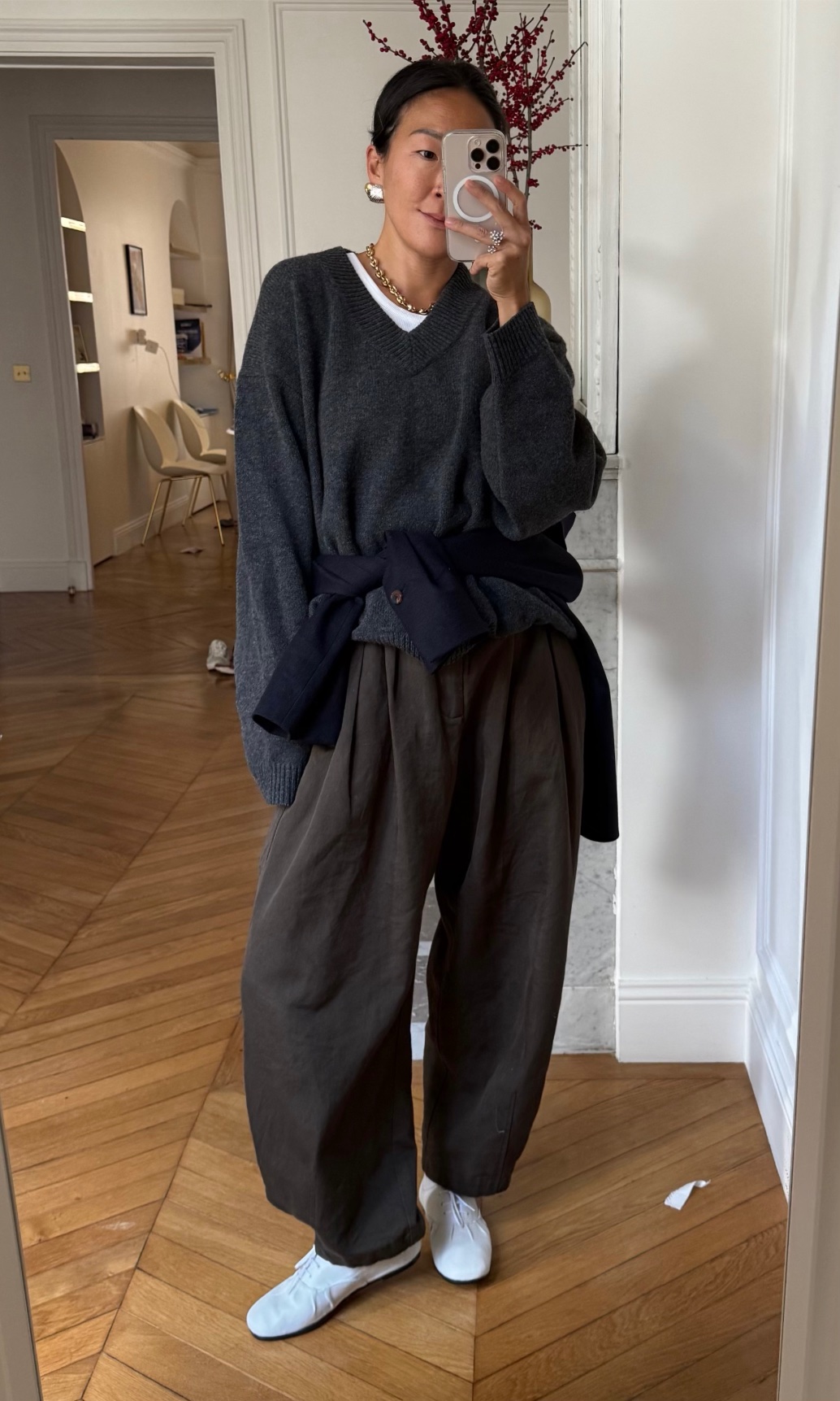 Irene Kim wearing a sweater, pants, and flats