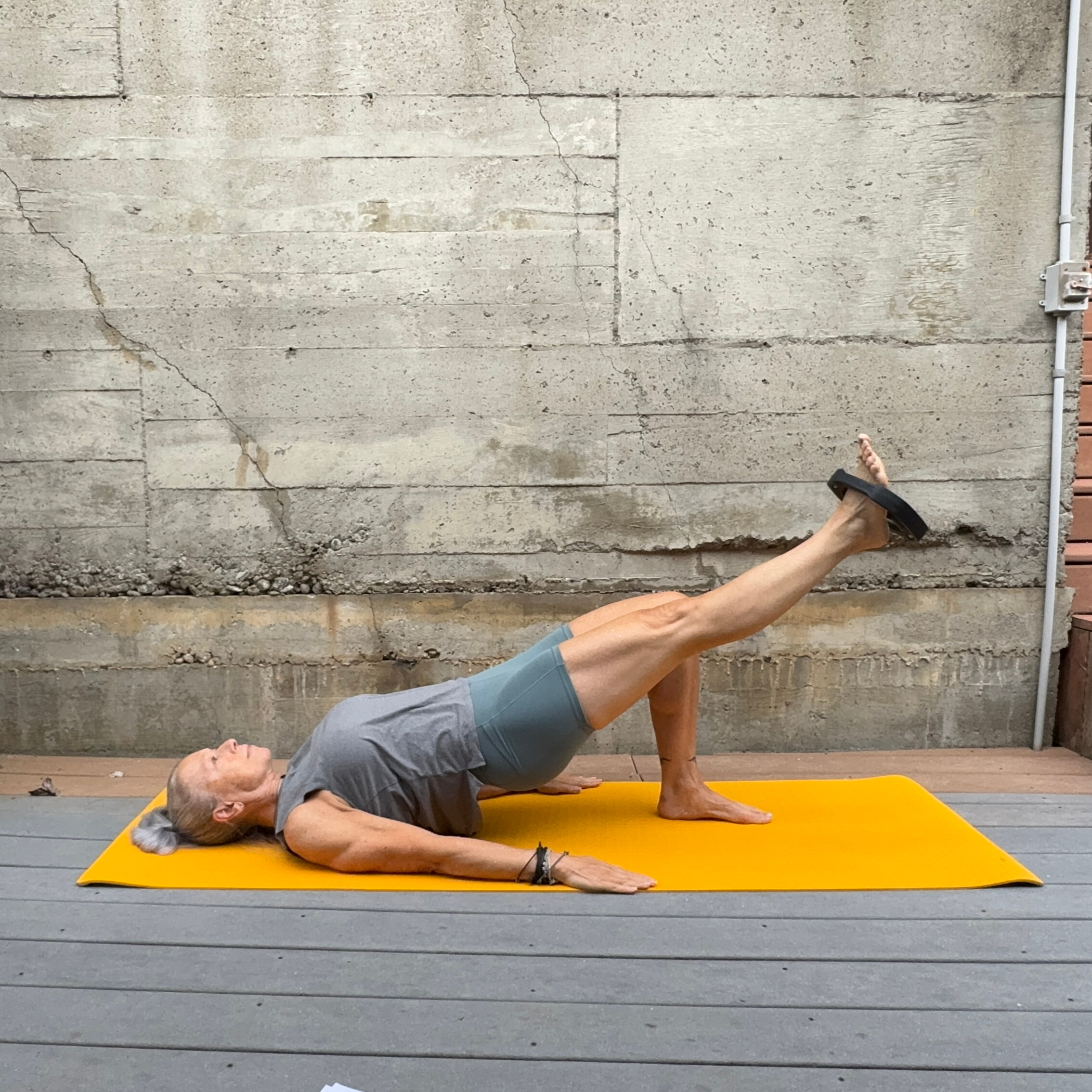 Woman exercising with weight plate