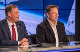 SpaceX CEO Elon Musk (right) and NASA chief Jim Bridenstine celebrate the successful first launch of a Crew Dragon spacecraft at NASA's Kennedy Space Center in Cape Canaveral, Florida on March 2, 2019.