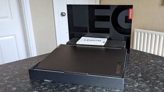 Lenovo Legion Slim 7i (Gen 8) unboxing with packaging on a table