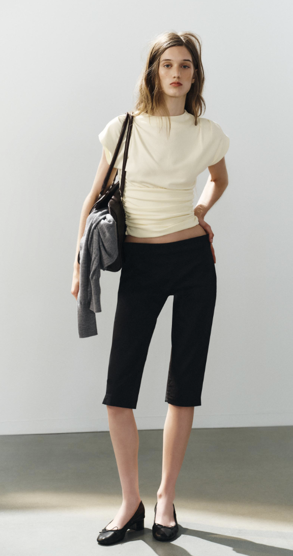 Zara early autumn colour trends 2026. The model wears an ecru top with black capri's and black heeled ballet pumps.
