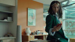 Annie Murphy looking at a phone in Black Mirror season 6